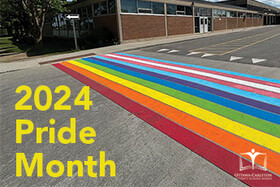 a crosswalk painted in rainbow colours for pride month