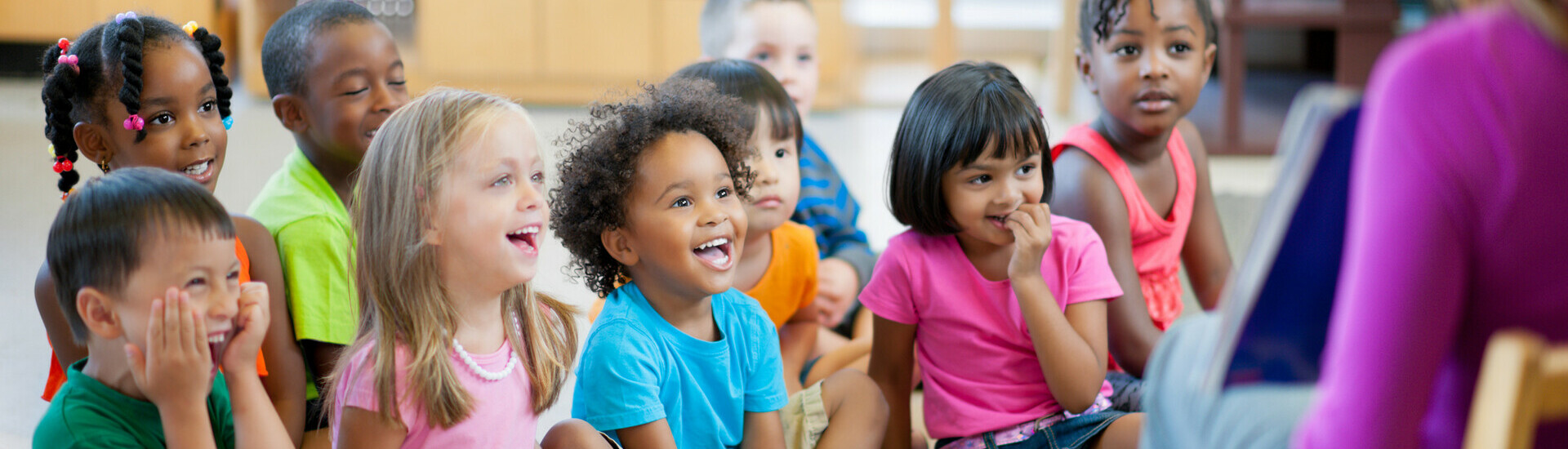 a kindergarten teacher reading to a group of students